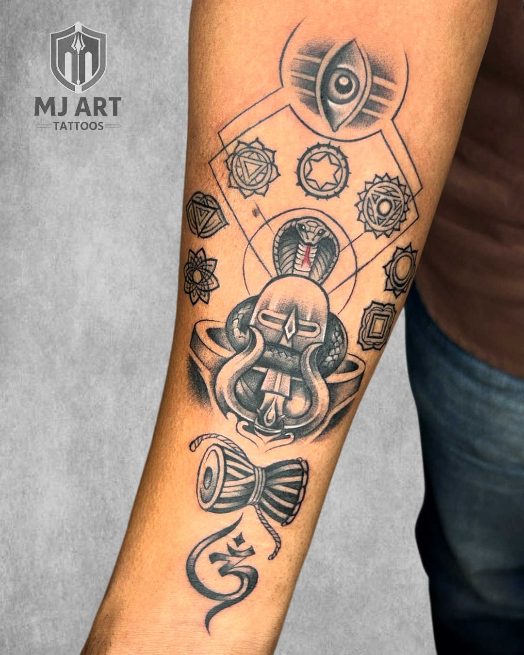 Shivling Chakra Damru Forearm Tattoo