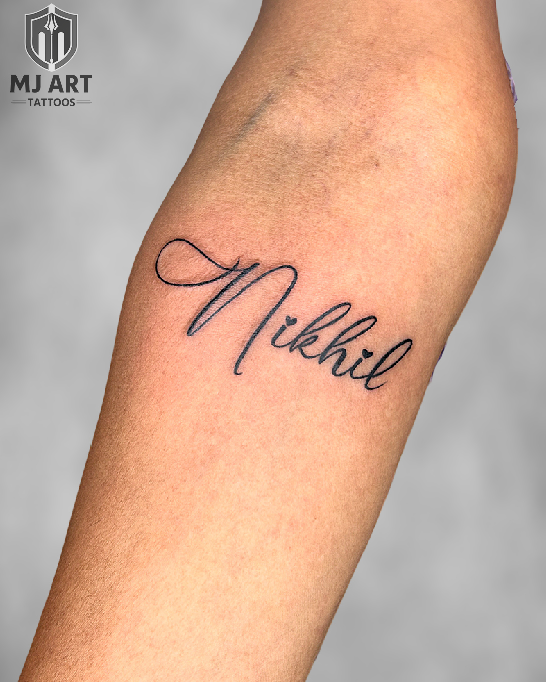 Nikhil Name Calligraphy Forearm Tattoo